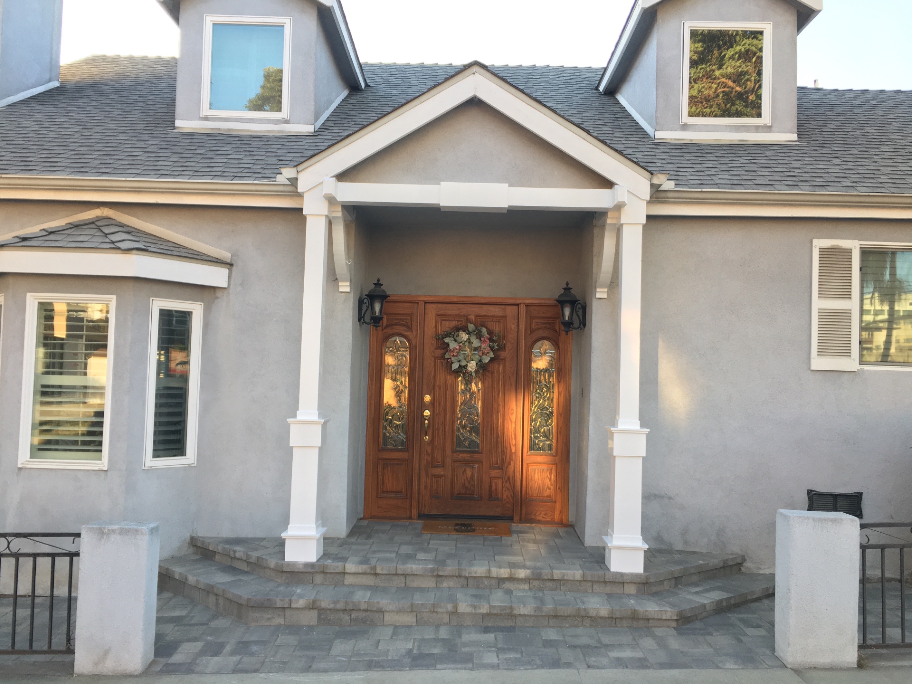 Porch rebuild — paver landing, columns, gable & new steps in Downey — after