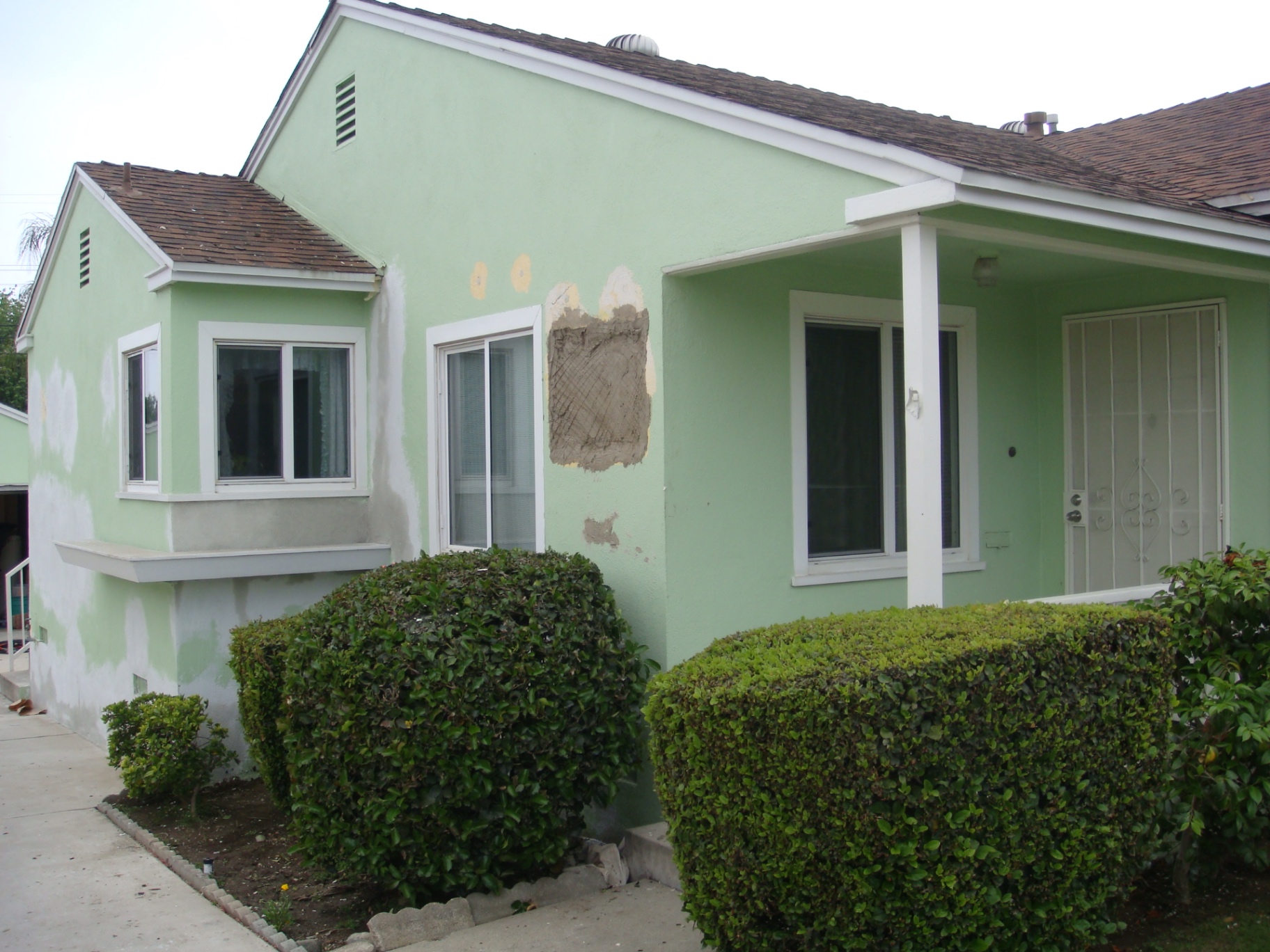 Stucco patch & full exterior re-coat in Long Beach — before