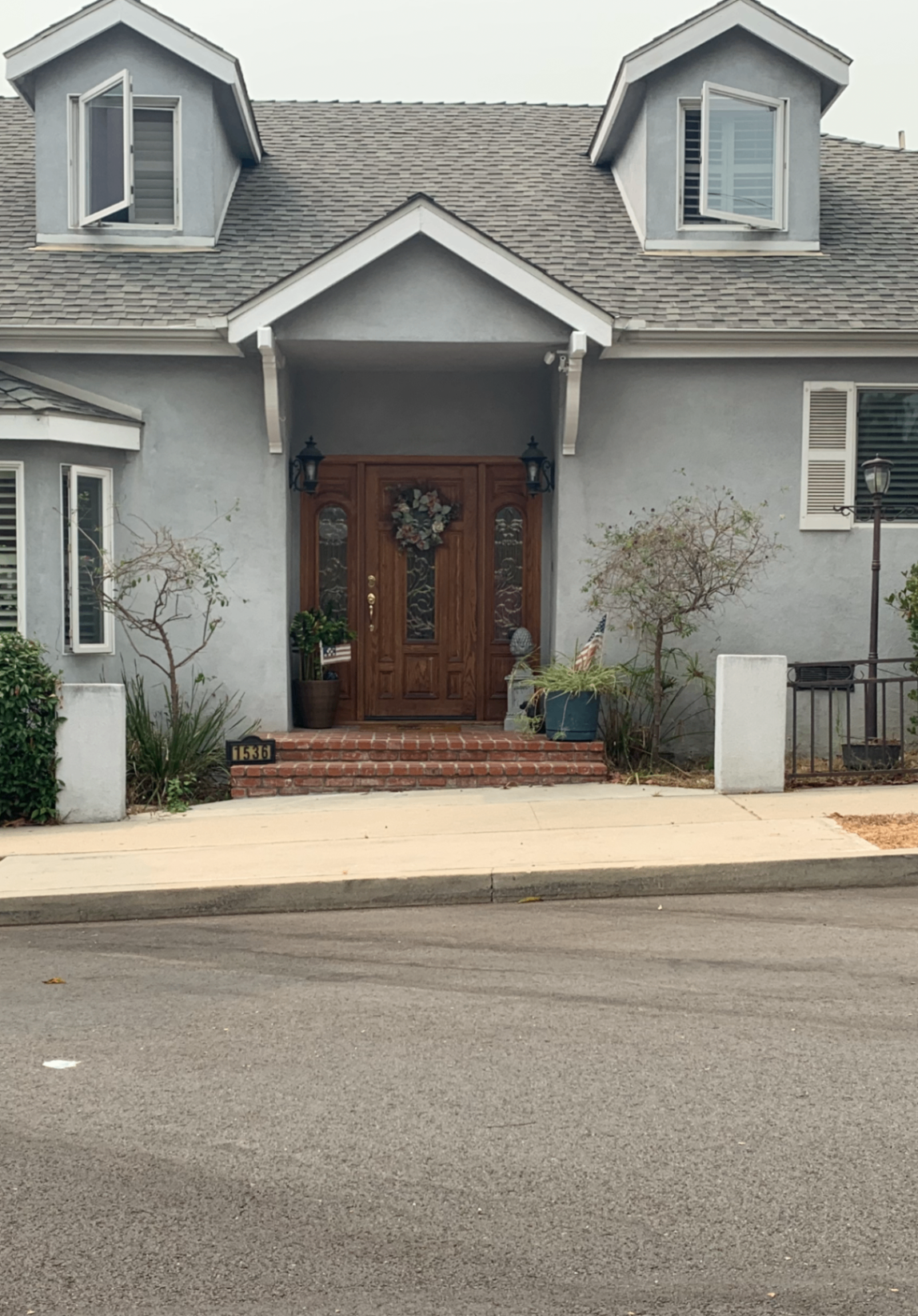 Porch rebuild — paver landing, columns, gable & new steps in Downey — before