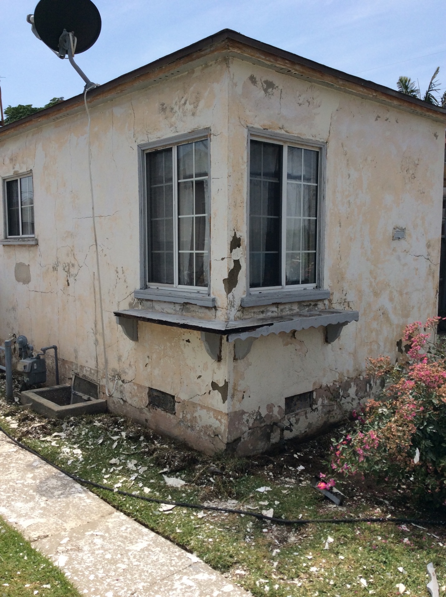 Failed stucco tear-off, new finish & trim paint in San Pedro — before