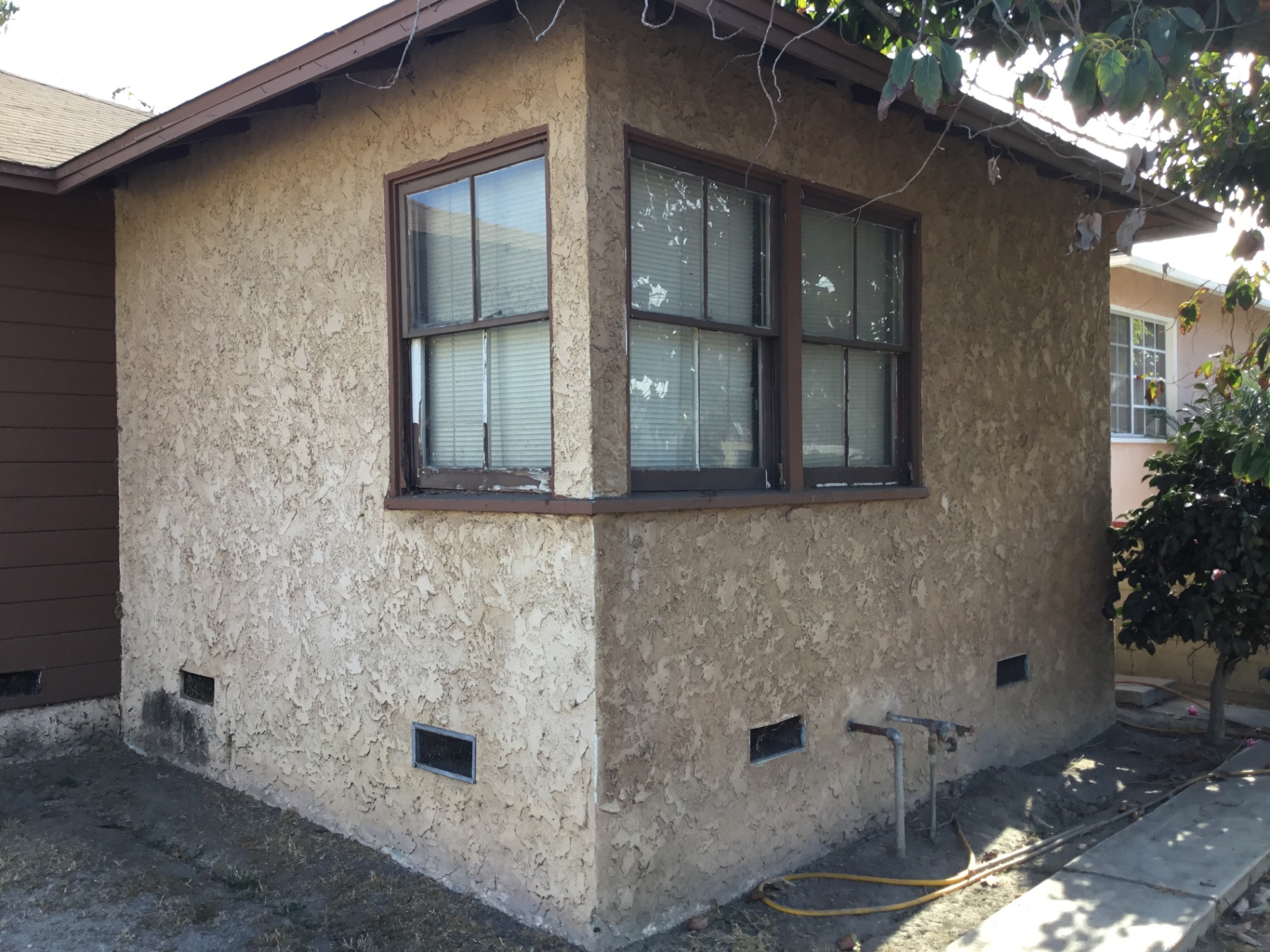 Re-stucco, retrofit windows, new sills in Torrance — before